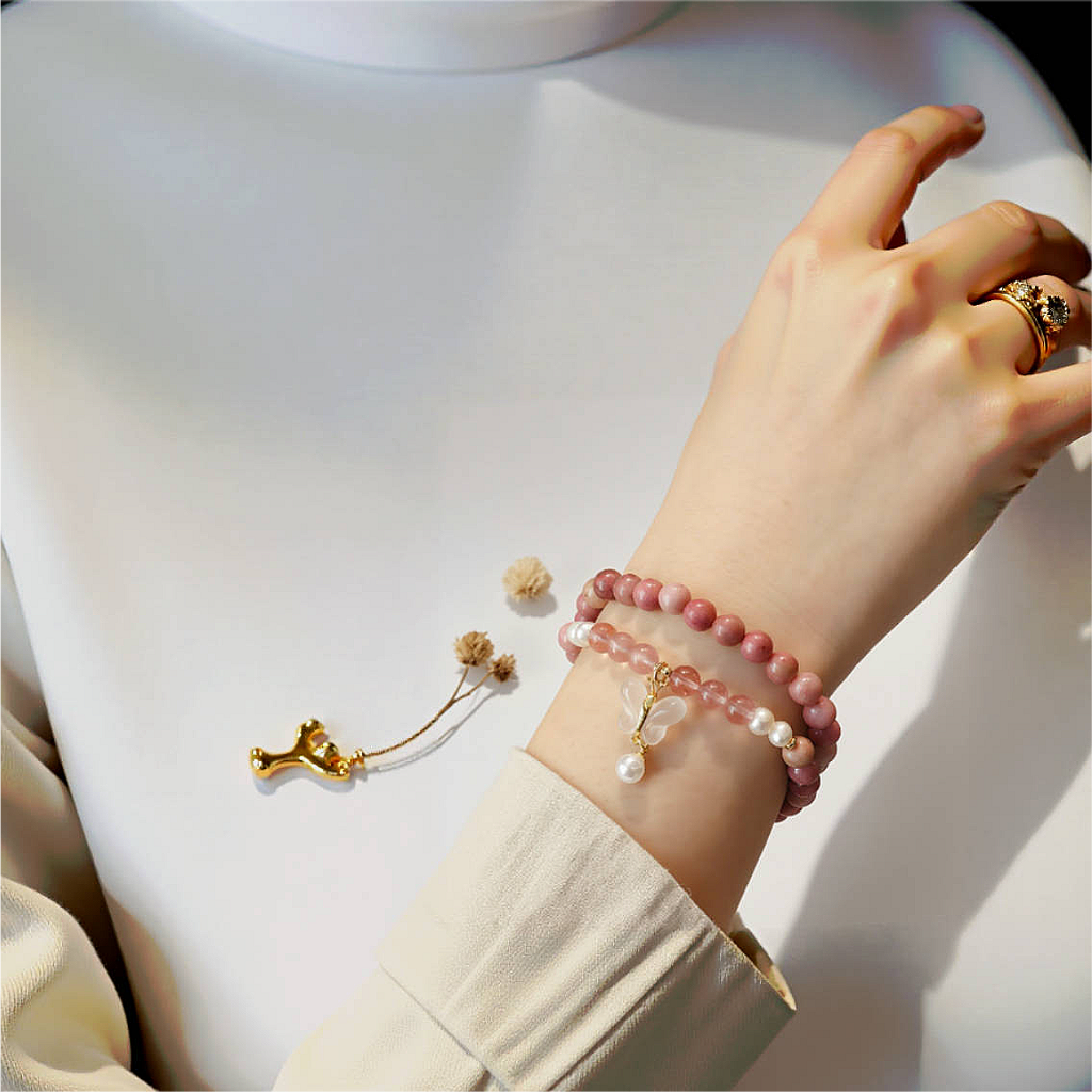 Double-layer Rhodochrosite and Chalcedony bracelet with butterfly and pearl charm, designed for sleep rituals and emotional rebirth.