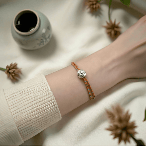 Silver Persimmon blessing thread bracelet with delicate orange weave and silver charm, symbolising luck and smooth flow for work mode rituals.